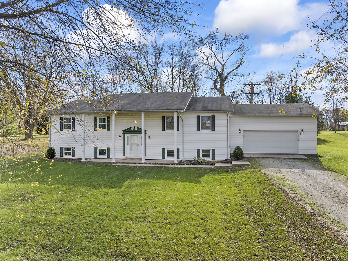 12945 Smith Road Manhattan, IL 60442 - Photo 1 of 43 a view of a white house with a large pool and a large tree