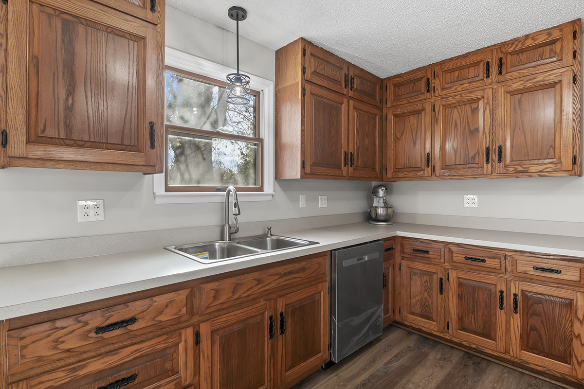 12945 Smith Road Manhattan, IL 60442 - Photo 14 of 43 a kitchen with stainless steel appliances granite countertop a sink and dishwasher with wooden cabinets