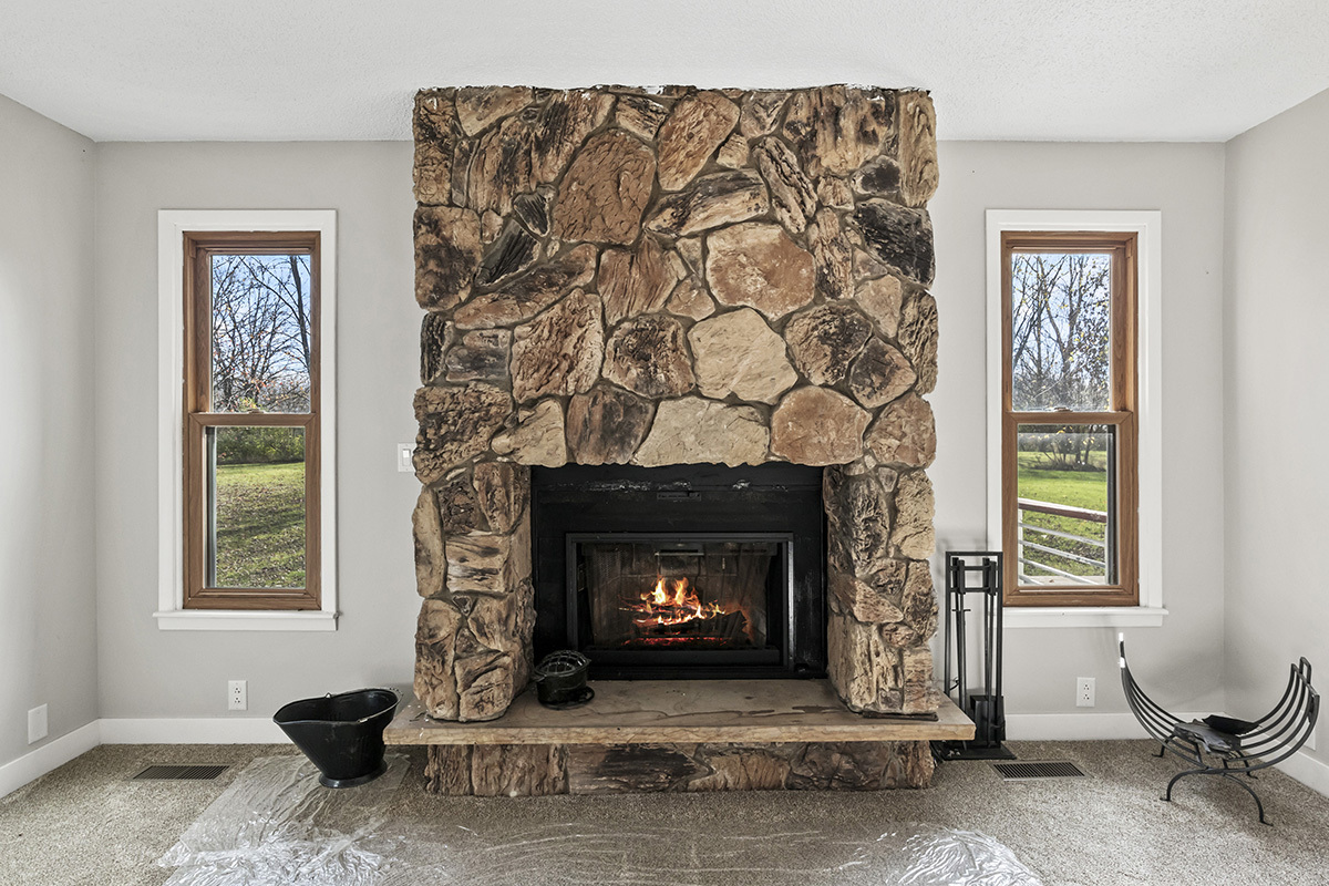 12945 Smith Road Manhattan, IL 60442 - Photo 7 of 43 a living room with a fireplace and a window