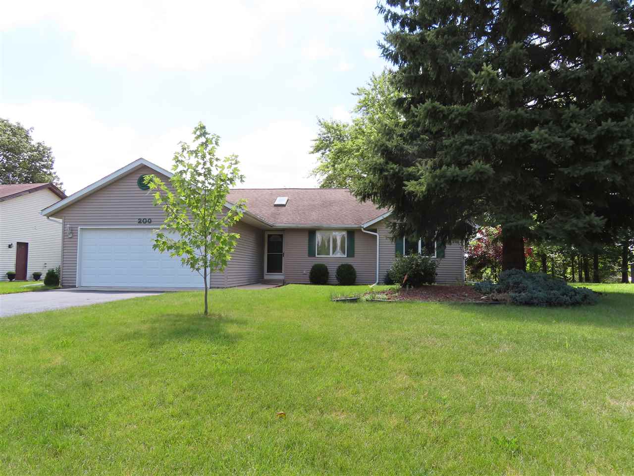 a view of a house with a yard and tree s