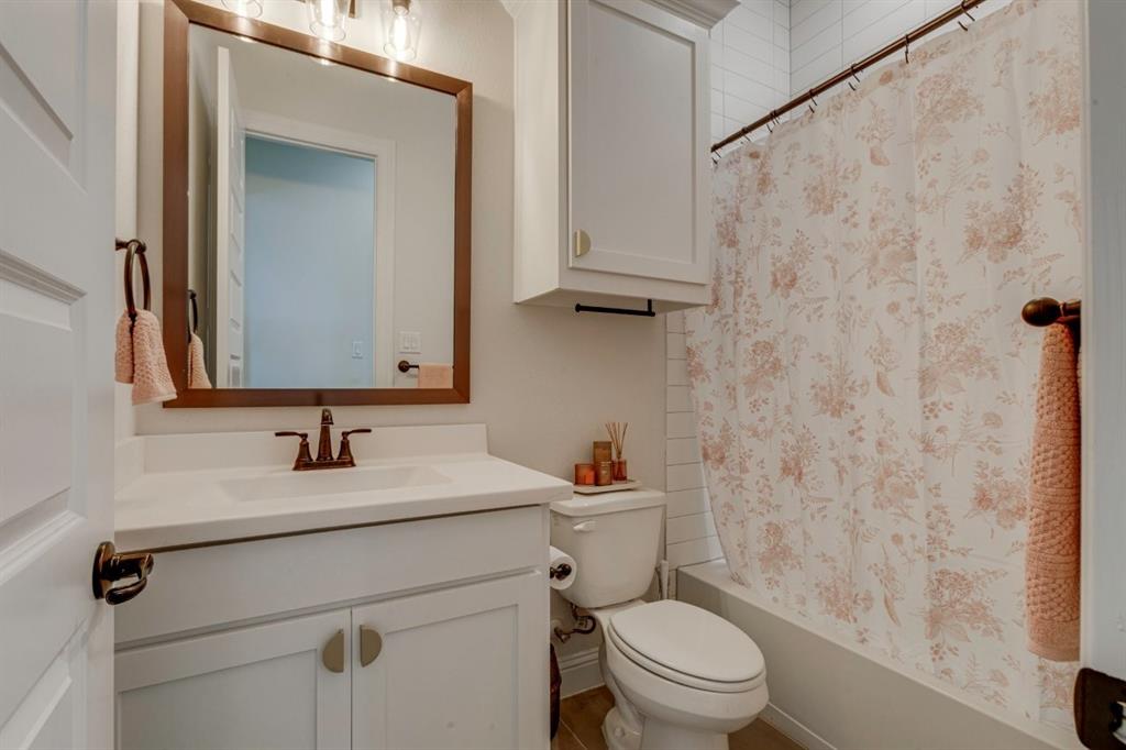 9613 Boulder Pt Road Oak Point, TX 75068 - Photo 23 of 28 Bathroom featuring a white vanity with integrated sink, rectangular mirror, and a bronze-finish faucet