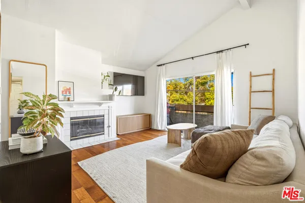 a living room with furniture fireplace and flat screen tv