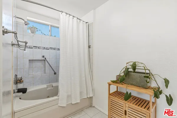 a bathroom with a bathtub and shower