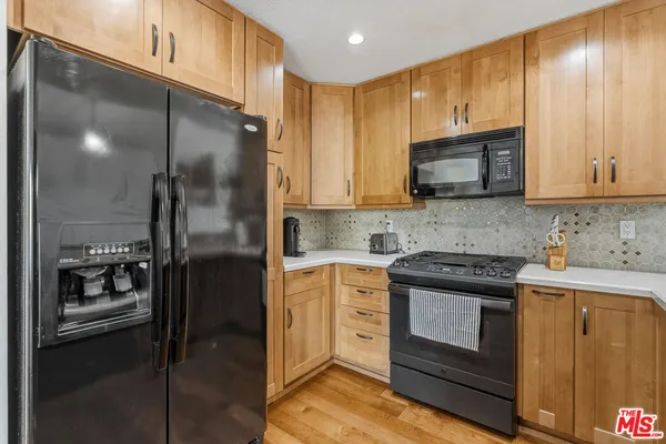 a kitchen with a refrigerator stove and microwave