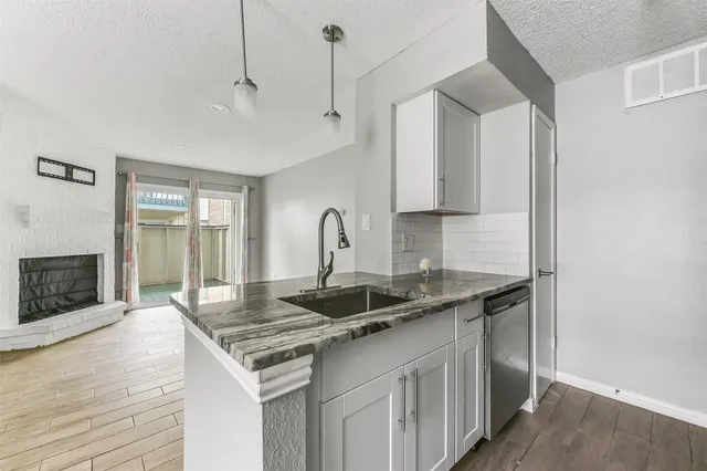 a kitchen with a sink and a refrigerator