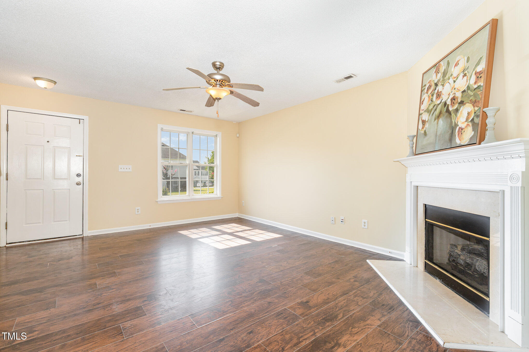 2125 Ventana Lane Raleigh, NC 27604 - Photo 3 of 19 a view of an empty room with a fireplace and a window