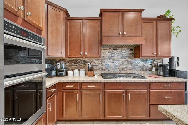 a kitchen with a potted plant on the counter and cabinets