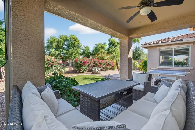 a view of a house with a yard and potted plants