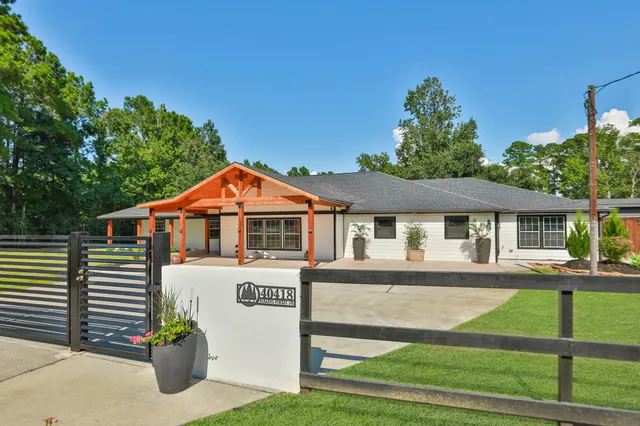 a front view of a house with a garden and plants