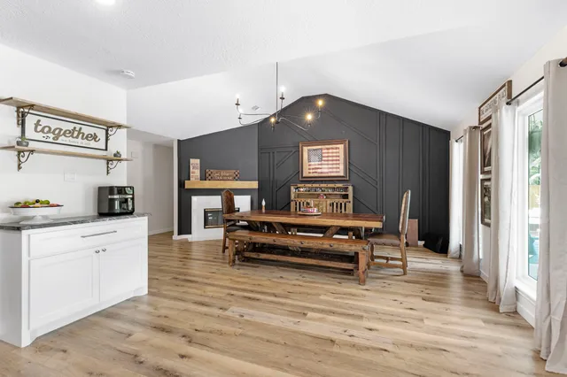 a large kitchen with stainless steel appliances granite countertop a lot of counter space and wooden floor