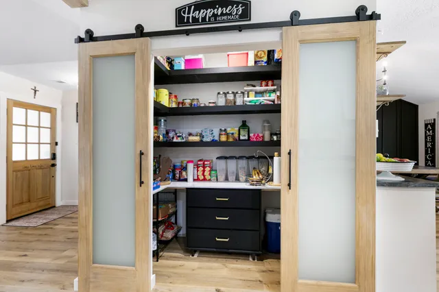 a view of hallway with cabinets and furniture