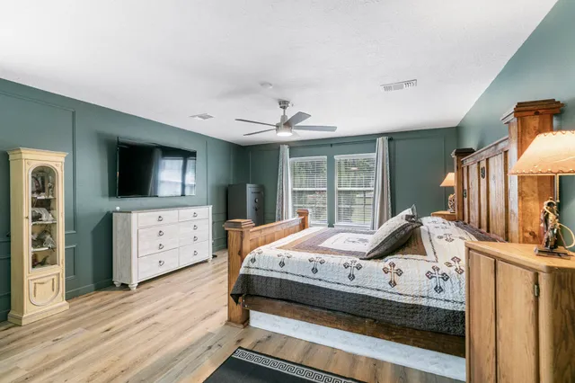 a bed sitting in a bedroom next to a window