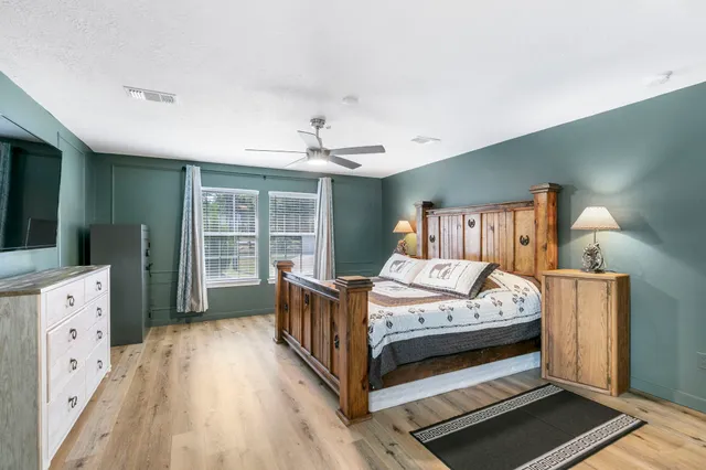 a bed room with a bed and a television