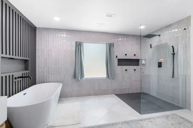a bathroom with a bathtub and a mirror