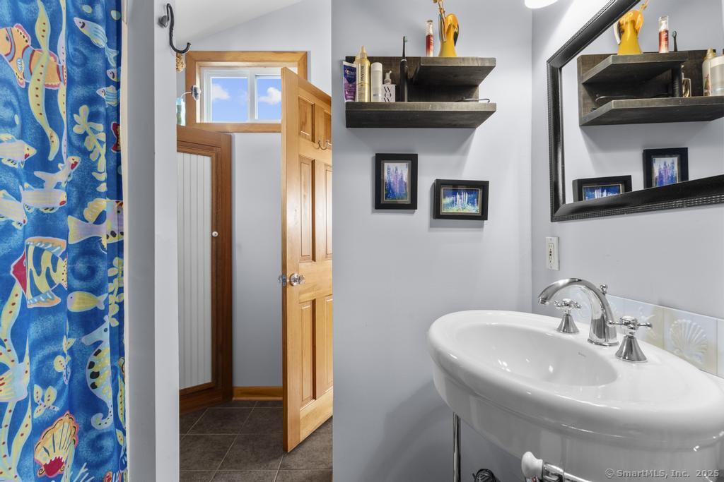 38 Elaine Road Milford, CT 06460 - Photo 2 of 13 a bathroom with a sink and a mirror
