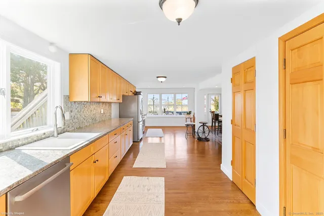 a view of a kitchen with kitchen island wooden floor and a window