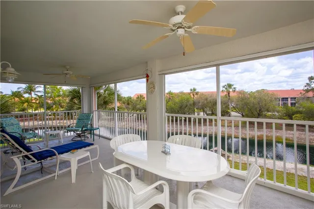 a balcony with table and chairs
