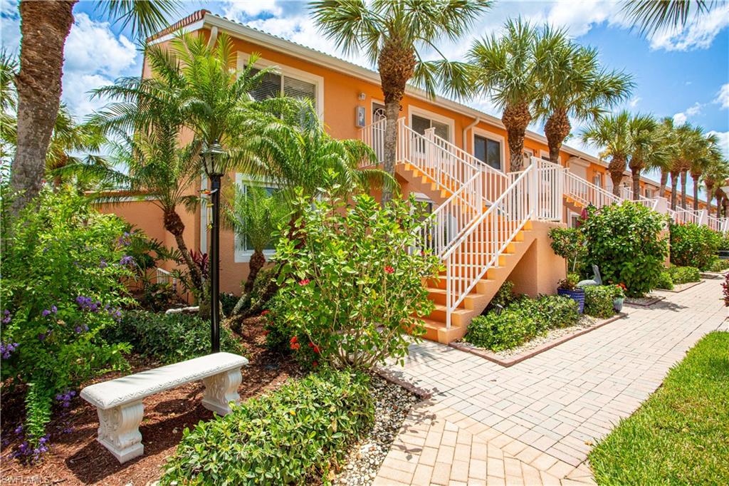 6760 Beach Resort Drive, Unit 2 Naples, FL 34114 - Photo 18 of 24 a view of a house with a yard and plant