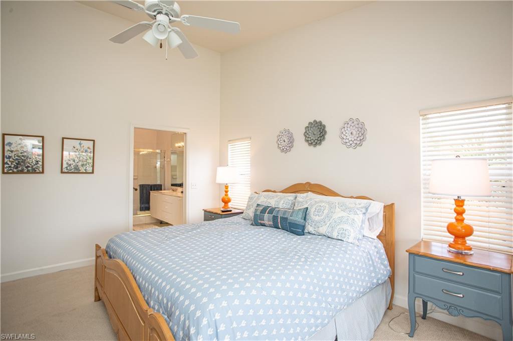 6760 Beach Resort Drive, Unit 2 Naples, FL 34114 - Photo 10 of 24 a bedroom with a bed and a chandelier