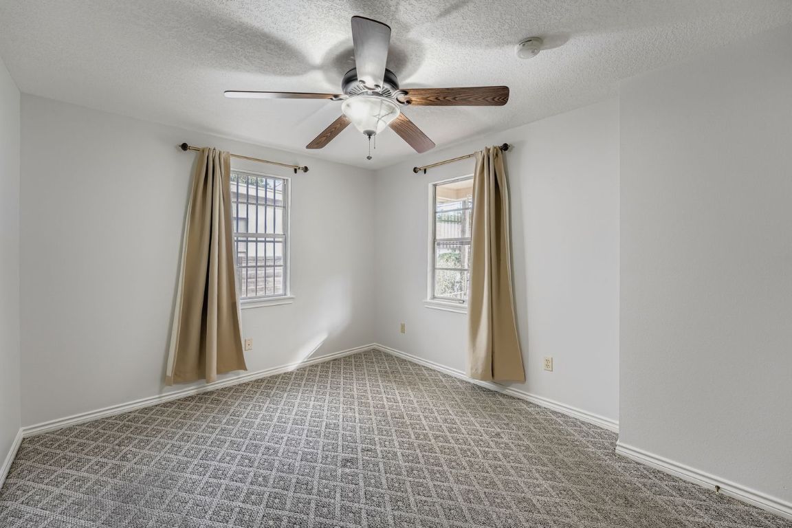2308 Santa Rita Street Austin, TX 78702 - Photo 14 of 27 an empty room with windows and fan