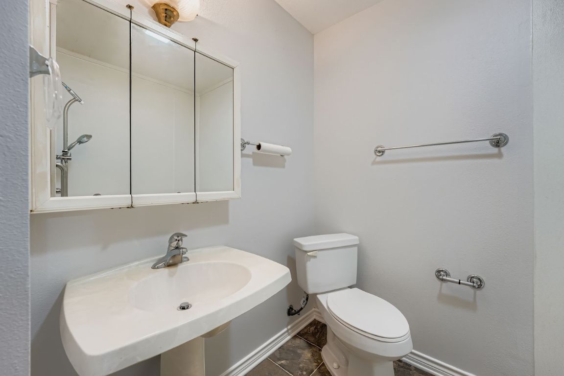 2308 Santa Rita Street Austin, TX 78702 - Photo 16 of 27 a white toilet sitting next to a bathroom sink