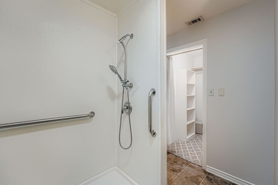 2308 Santa Rita Street Austin, TX 78702 - Photo 17 of 27 a bathroom with a glass shower door