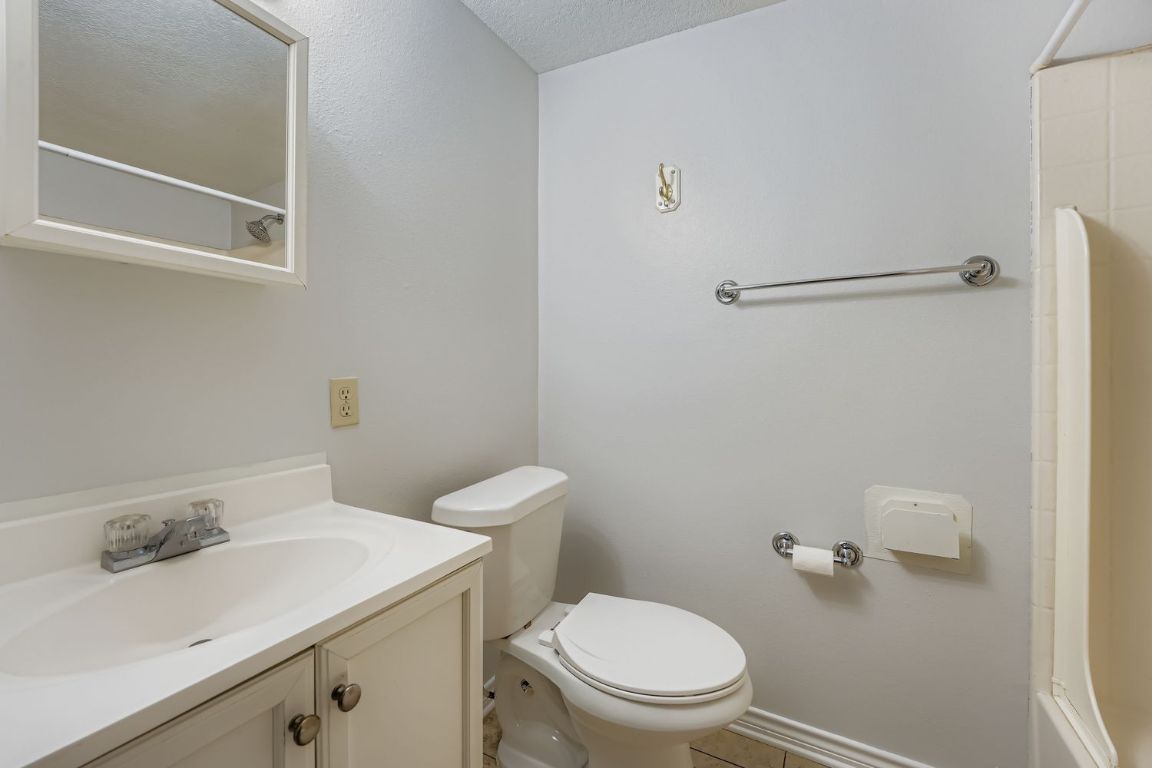 2308 Santa Rita Street Austin, TX 78702 - Photo 21 of 27 a white toilet sitting next to a bathroom sink