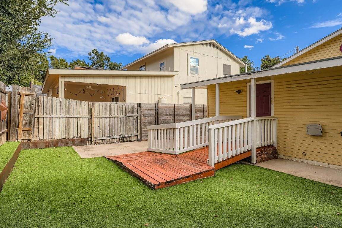 2308 Santa Rita Street Austin, TX 78702 - Photo 25 of 27 a view of a backyard with a small deck and a garden