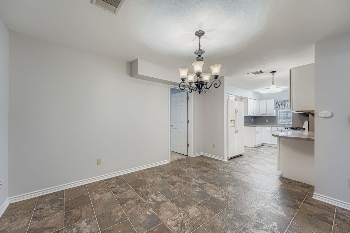 2308 Santa Rita Street Austin, TX 78702 - Photo 6 of 27 a view of a kitchen with a sink and chandelier