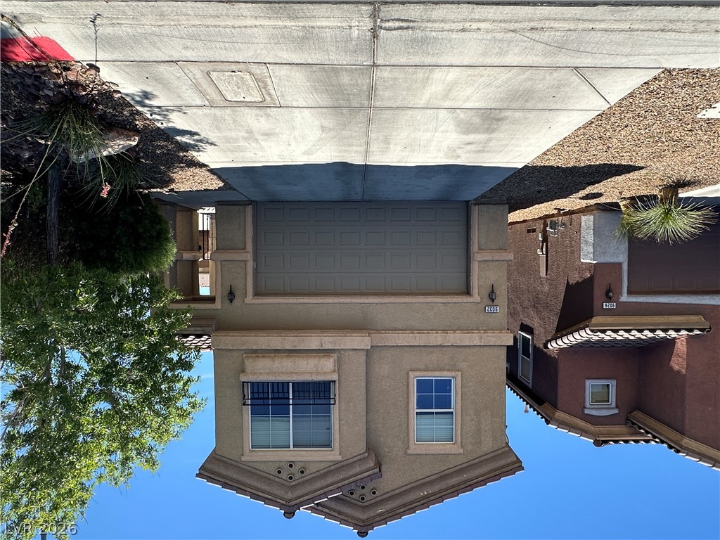 A welcoming facade showcases a tiled roof and an integrated garage, perfect for modern living.