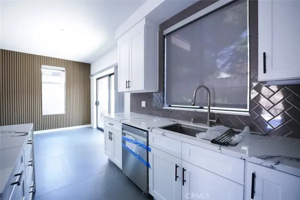 a kitchen with stainless steel appliances granite countertop a sink and a granite counter tops