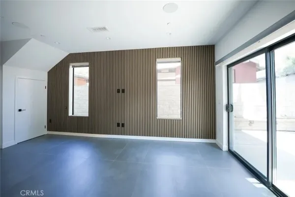 a view of a hallway with entryway and stairs
