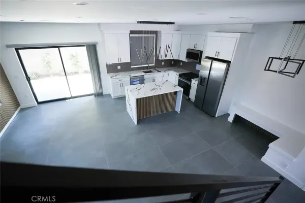a view of an empty room with wooden floor and closet