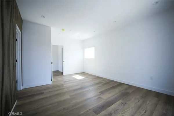 a view of hallway with wooden floor