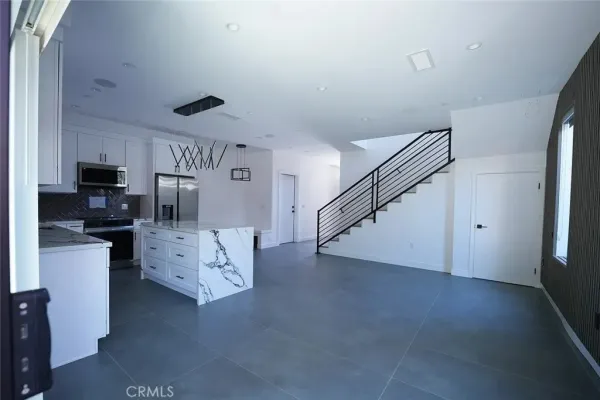 a view of kitchen with furniture and wooden floor