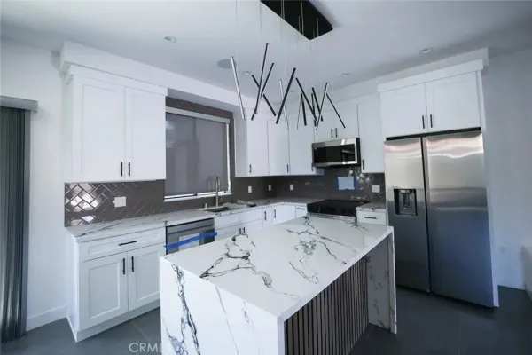 a kitchen with a sink appliances and cabinets