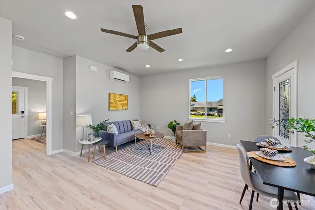 a living room with furniture and a wooden floor