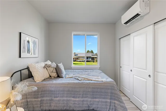 a bedroom with a bed and a window