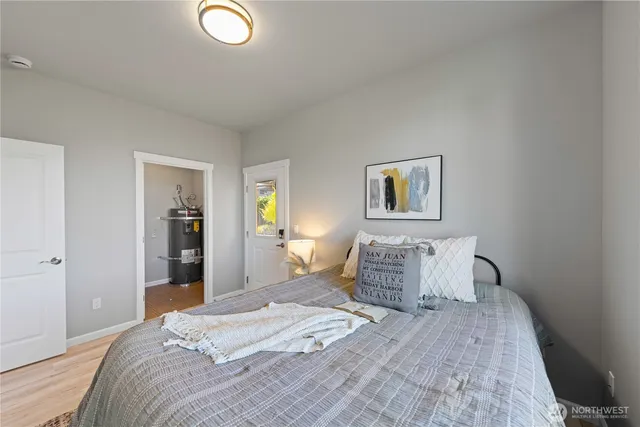 a bedroom with bed and night stand