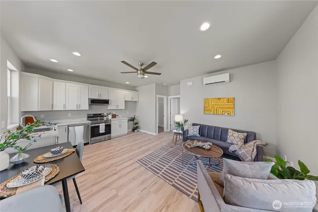 a living room with furniture and kitchen view