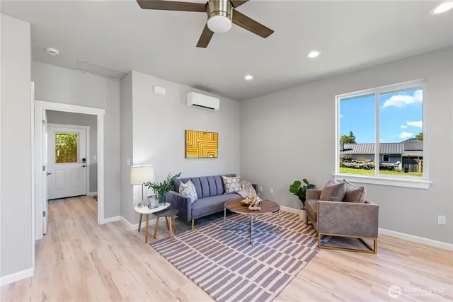 a living room with furniture and a wooden floor