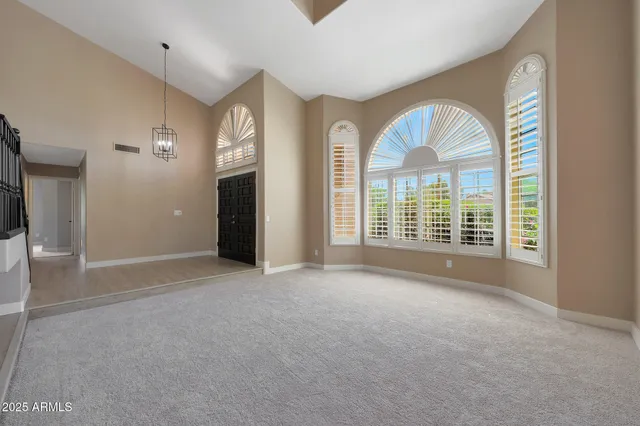 a kitchen with a sink wooden floor and stainless steel appliances