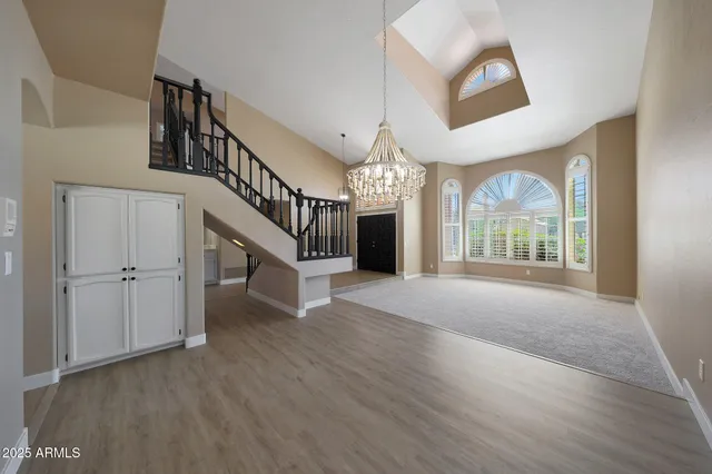 a kitchen with kitchen island granite countertop a sink cabinets and wooden floor