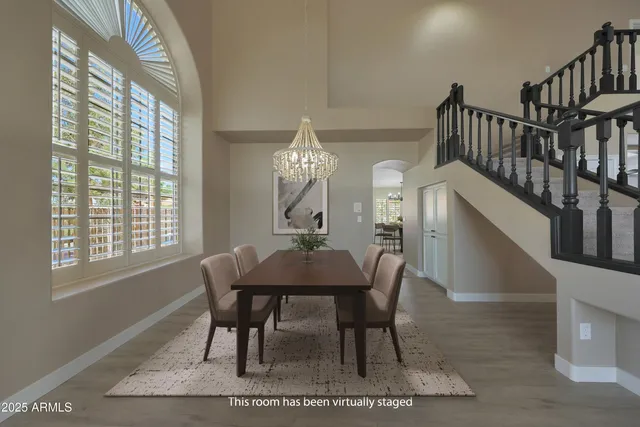 a kitchen with a refrigerator a sink dishwasher a stove and a dining table with wooden floor