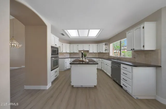 a kitchen with sink cabinets and wooden floor