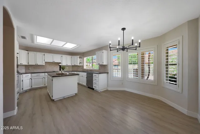 a view of an empty room with a fireplace and a window