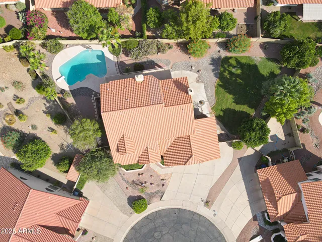 an aerial view of a house with a yard