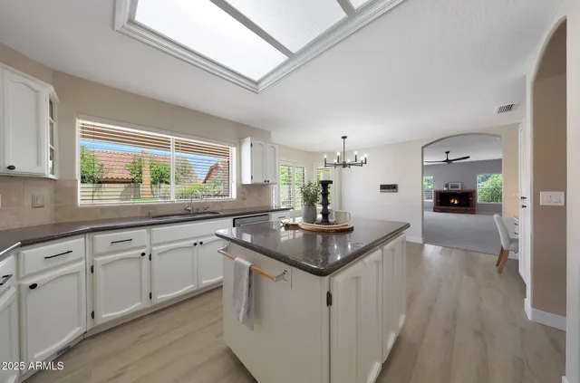 a bathroom with a granite countertop sink a toilet and a mirror