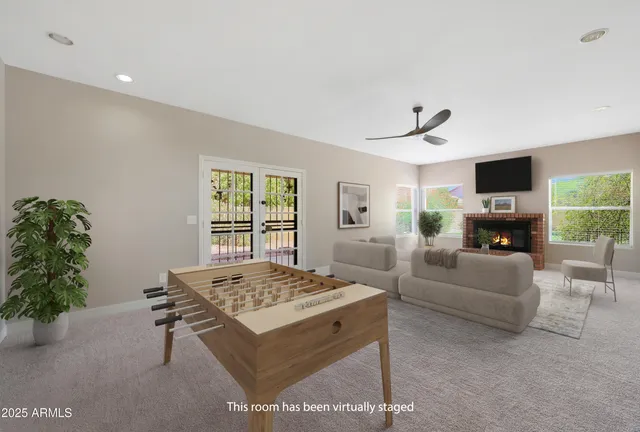 a view of a livingroom with a ceiling fan & window