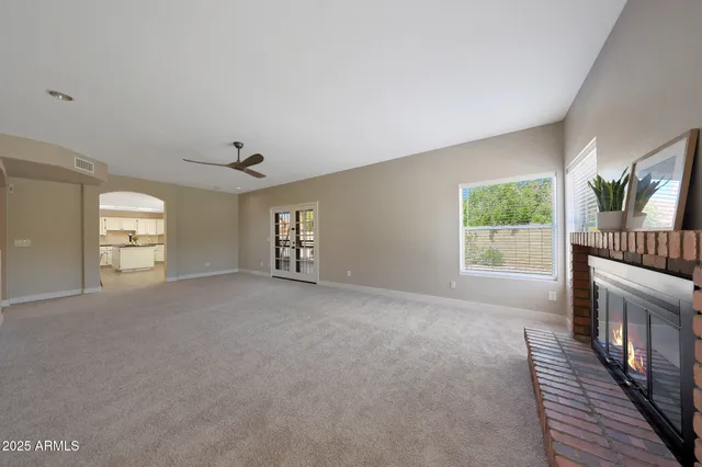 a view of a livingroom with a fireplace and window